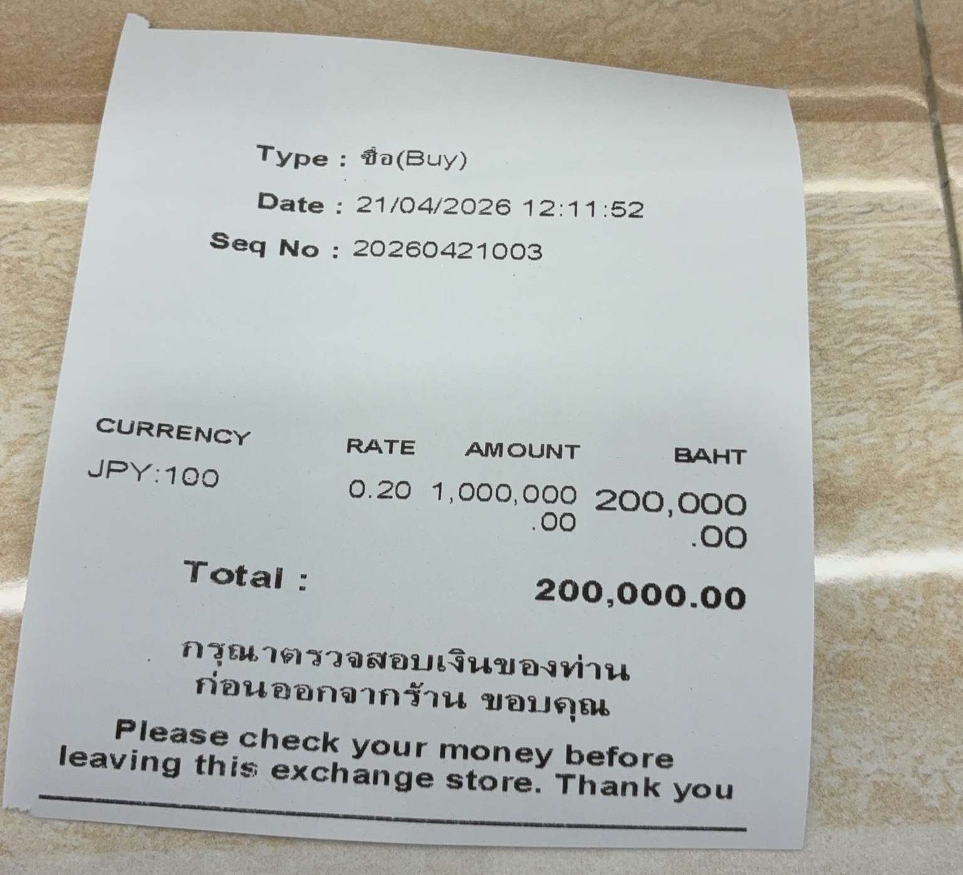 A Chiang Mai exchange receipt: 1,000,000 yen changed for 200,000 baht in April 2026